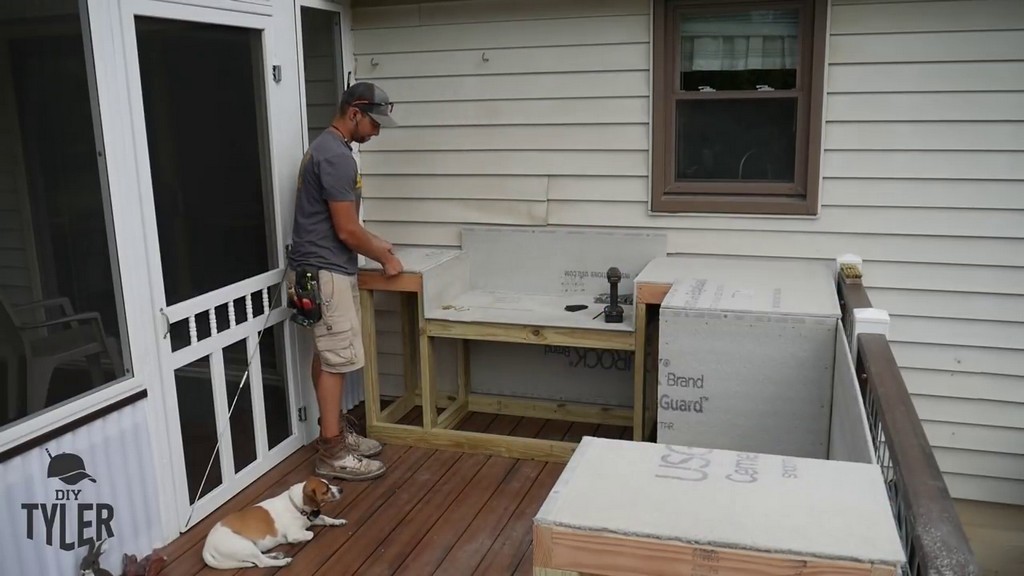 placing concrete board onto DIY outdoor kitchen frame