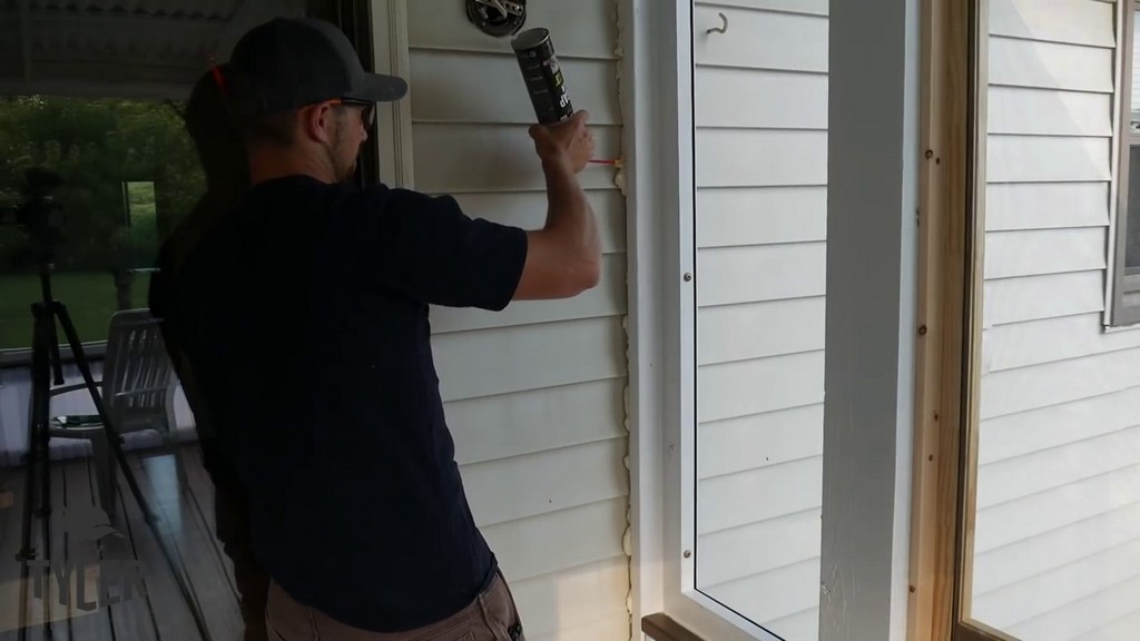 applying foam sealant to edges of screened in porch