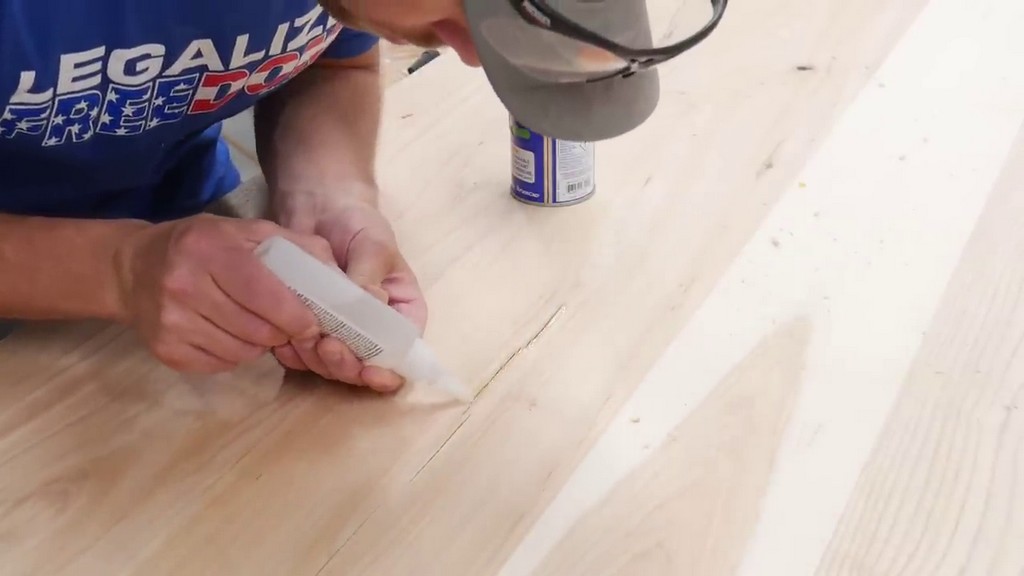 applying CA glue to cracks in hickory boards