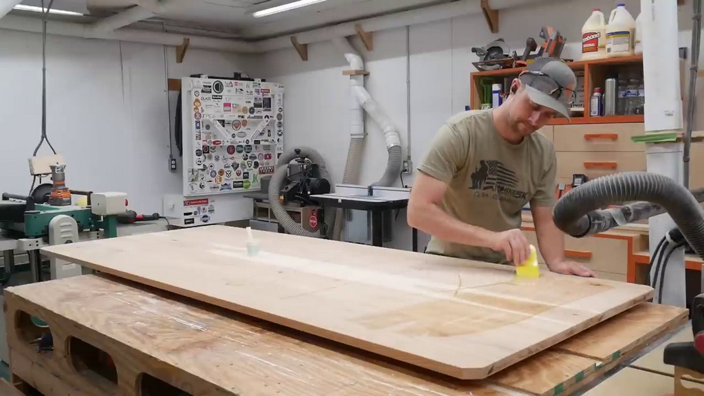 applying coat of finish to hickory farmhouse table