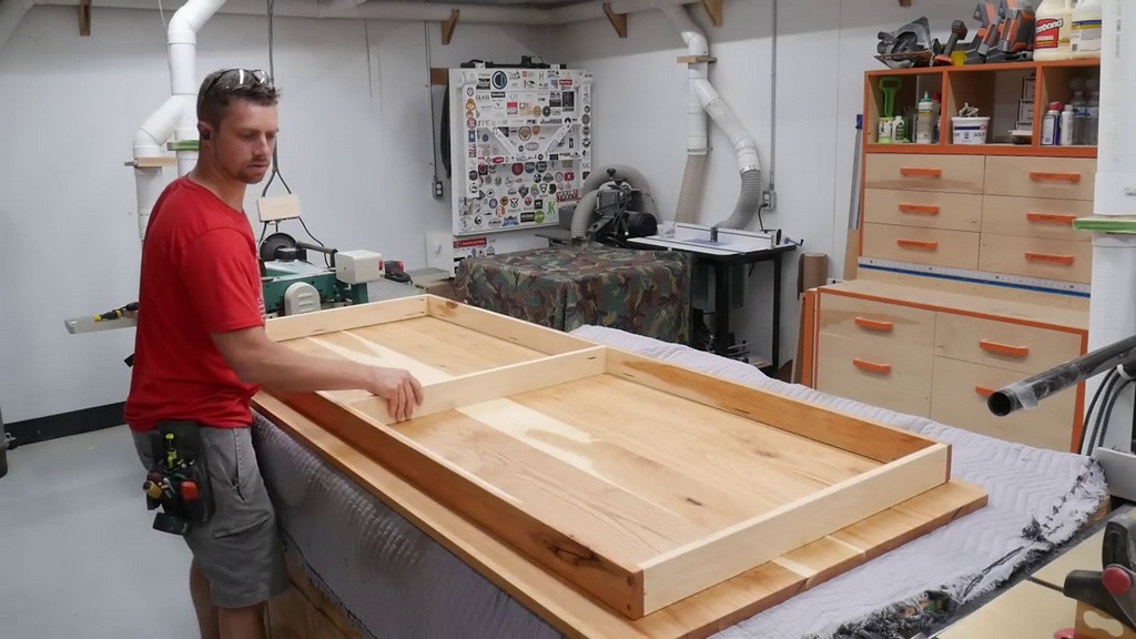 setting apron frame down onto underside of hickory kitchen table