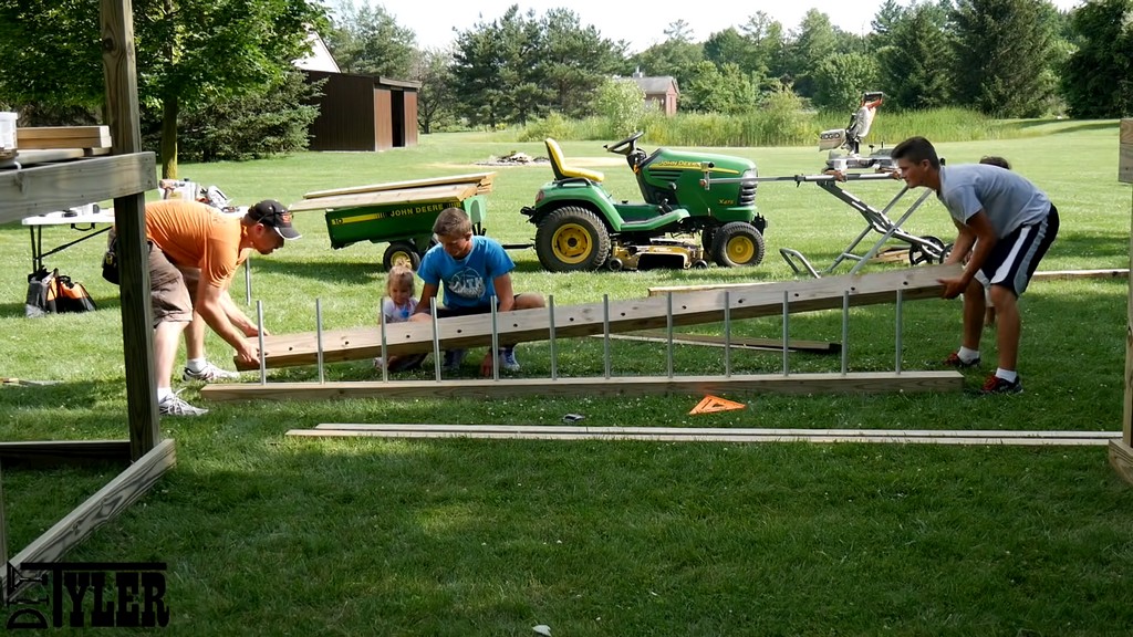 installing homemade monkey bars for diy backyard swing set