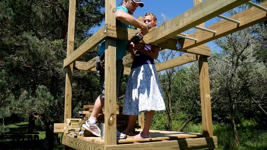 installing joists for upper level of diy backyard swing set tower