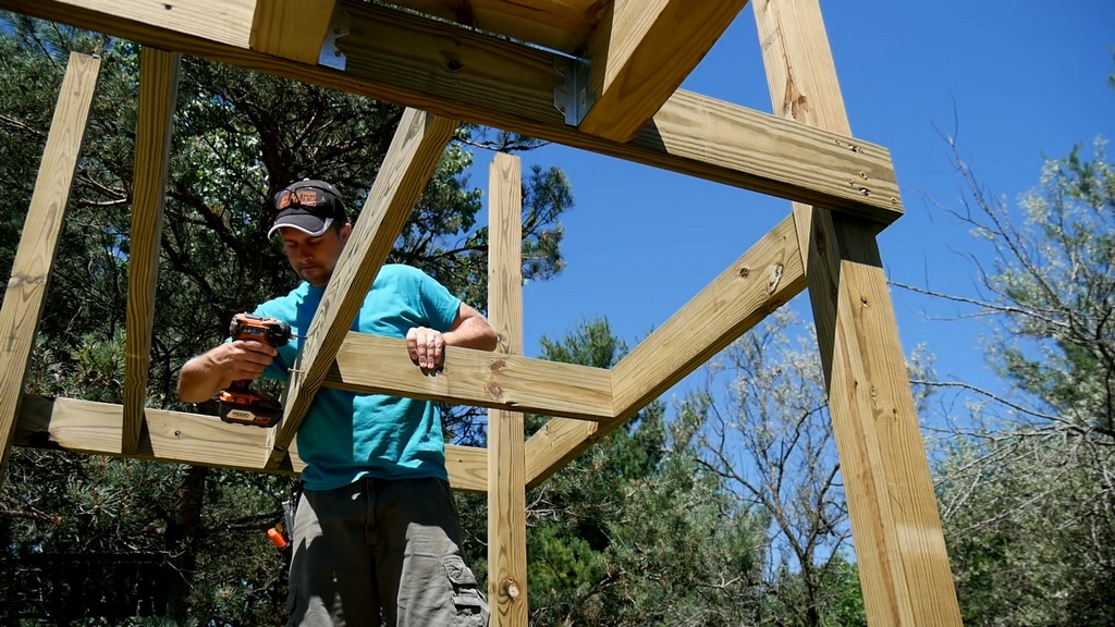 installing joists around stairway for diy backyard swing set tower