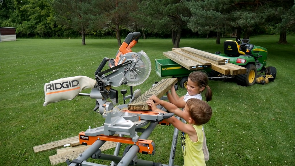 kids removing boards for diy backyard swing set