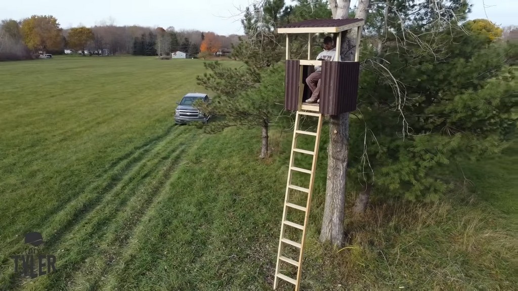 man sitting in completed diy deer stand