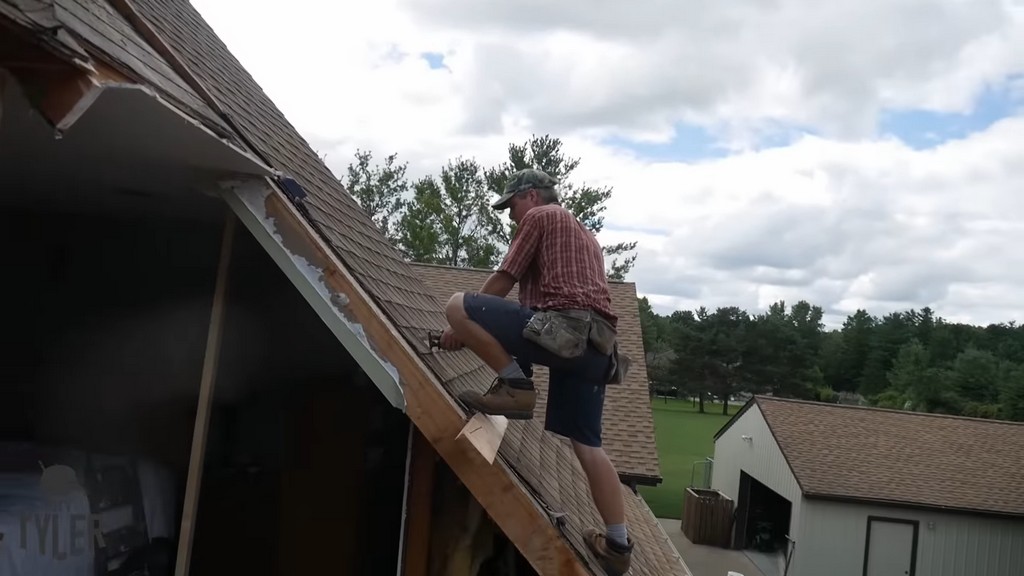 man cutting through roofing for diy dormer addition project