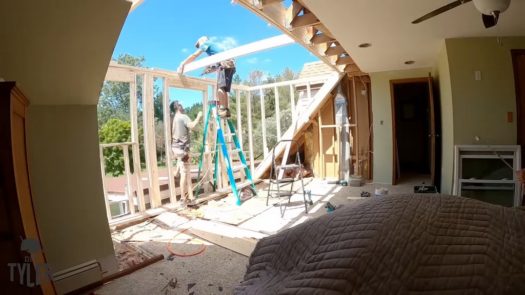 man working on frame for diy dormer addition