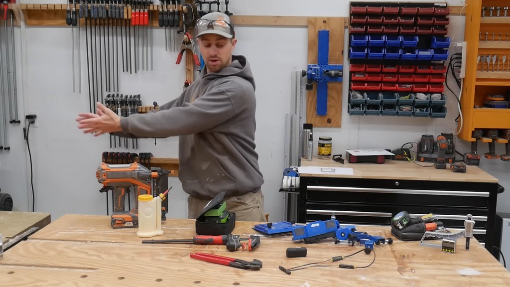 man standing in front of table filled with tools