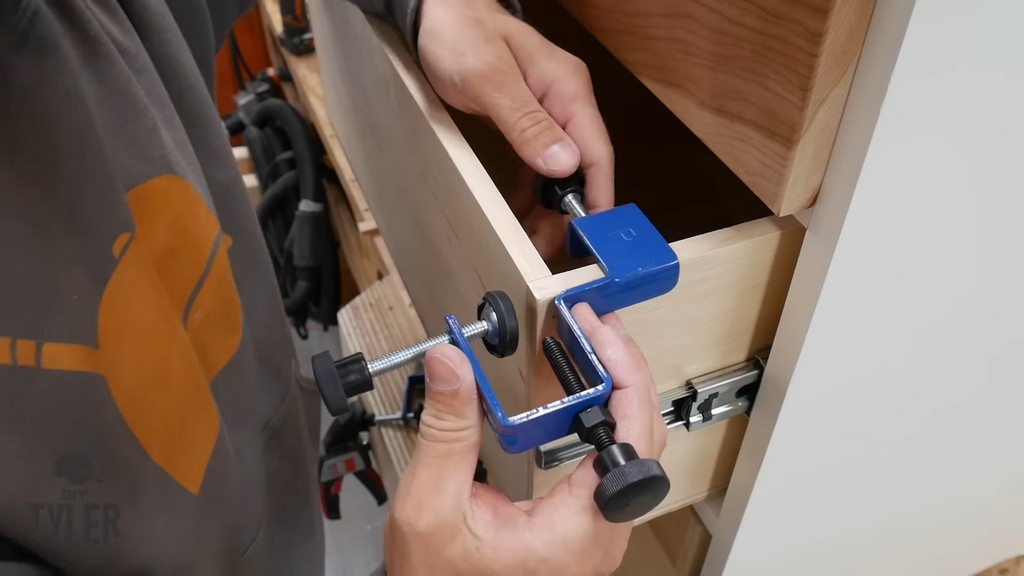 man clamping drawer front in place with ROCKLER clamp