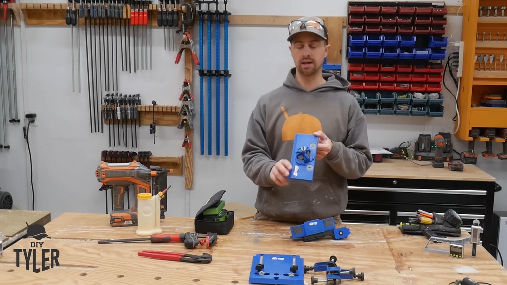 man holding up KREG jig for hinges