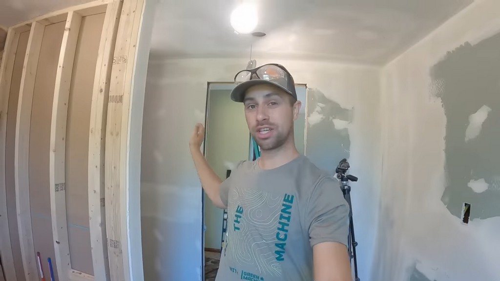 man standing in unfinished bathroom