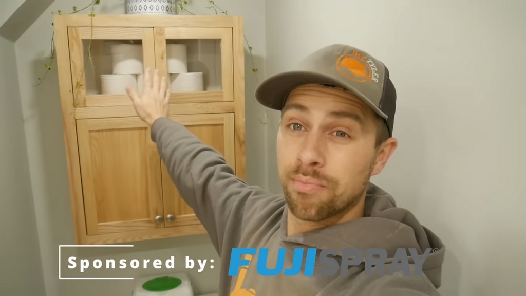 man gesturing to diy functional bathroom shelf