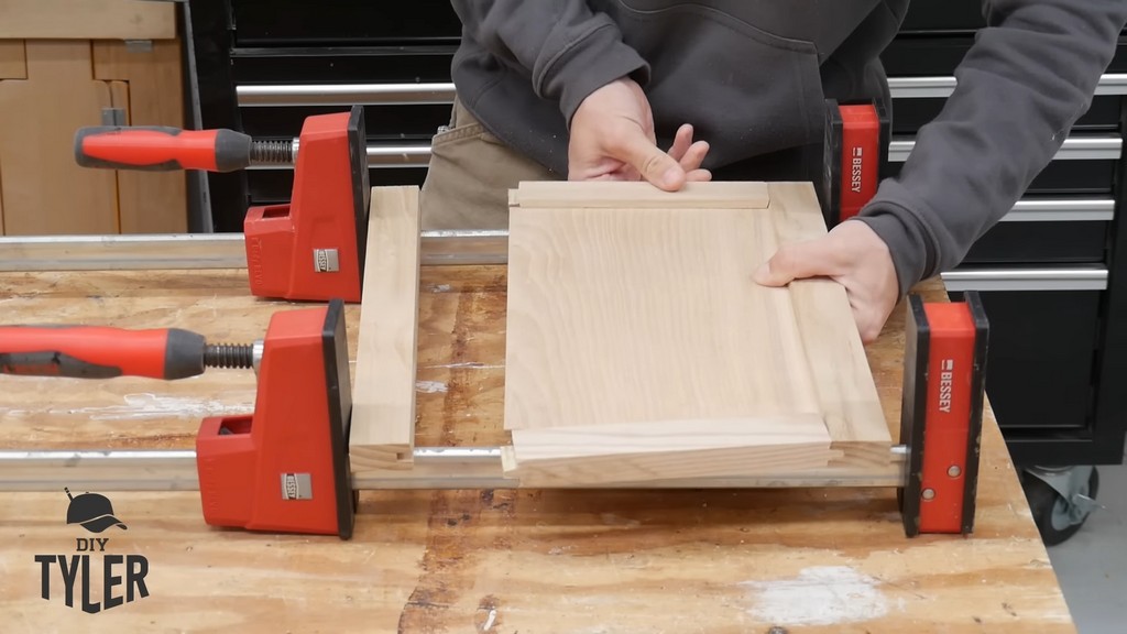 man assembling door frame for DIY functional bathroom shelf