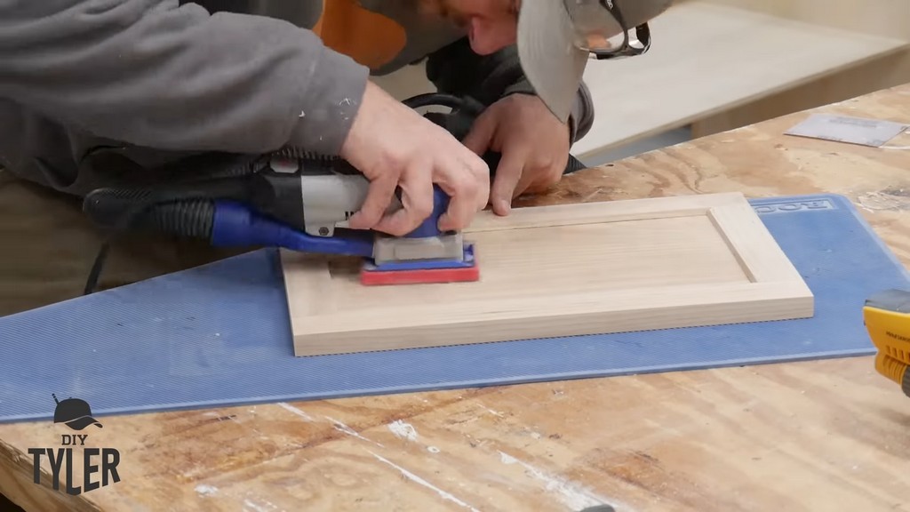 man sanding door frame