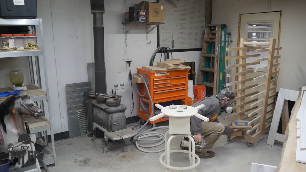 man setting door frame panel onto drying rack