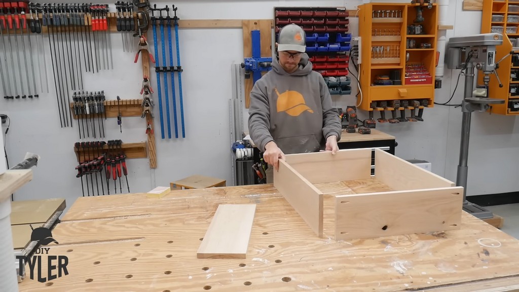 man assembling box for diy functional bathroom shelf