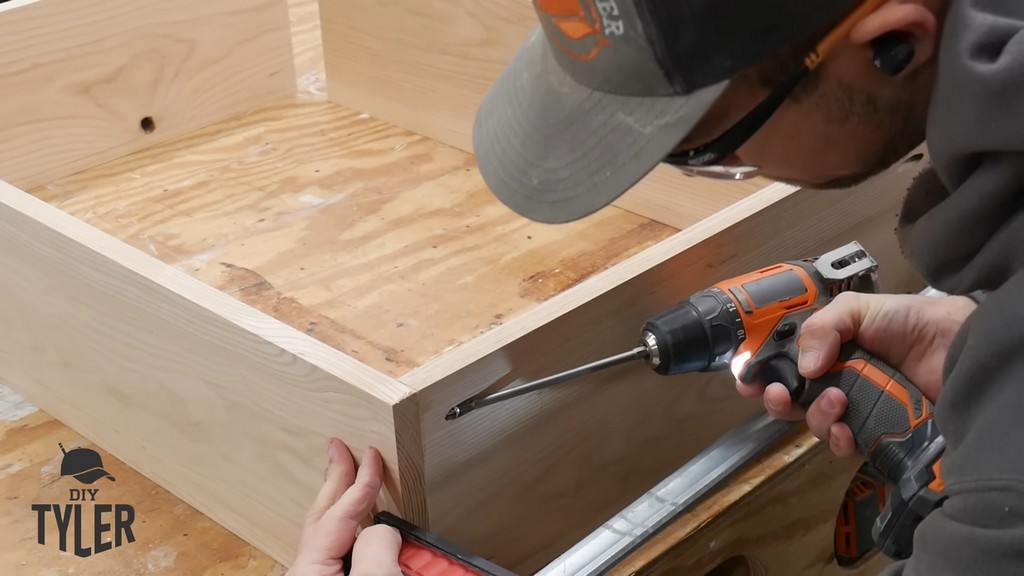 man drilling into pocket holes for DIY functional bathroom shelf