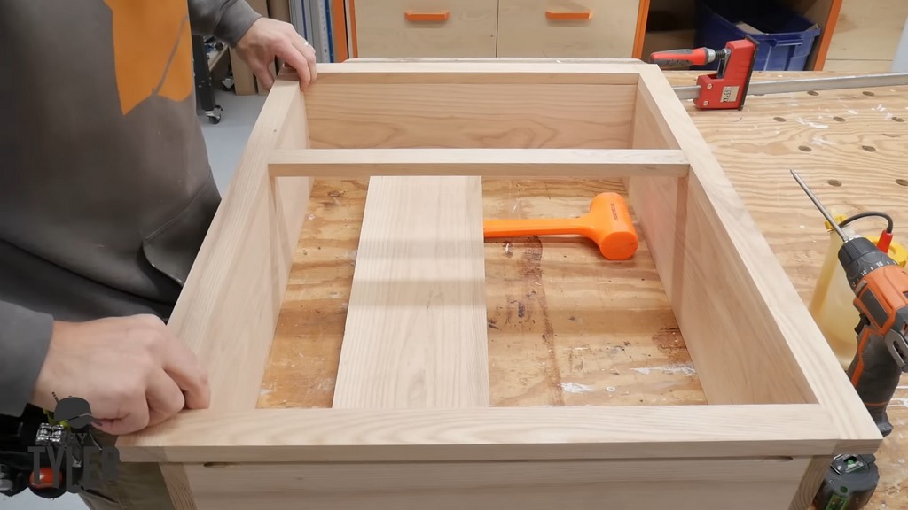 man preparing frame for DIY functional bathroom shelf