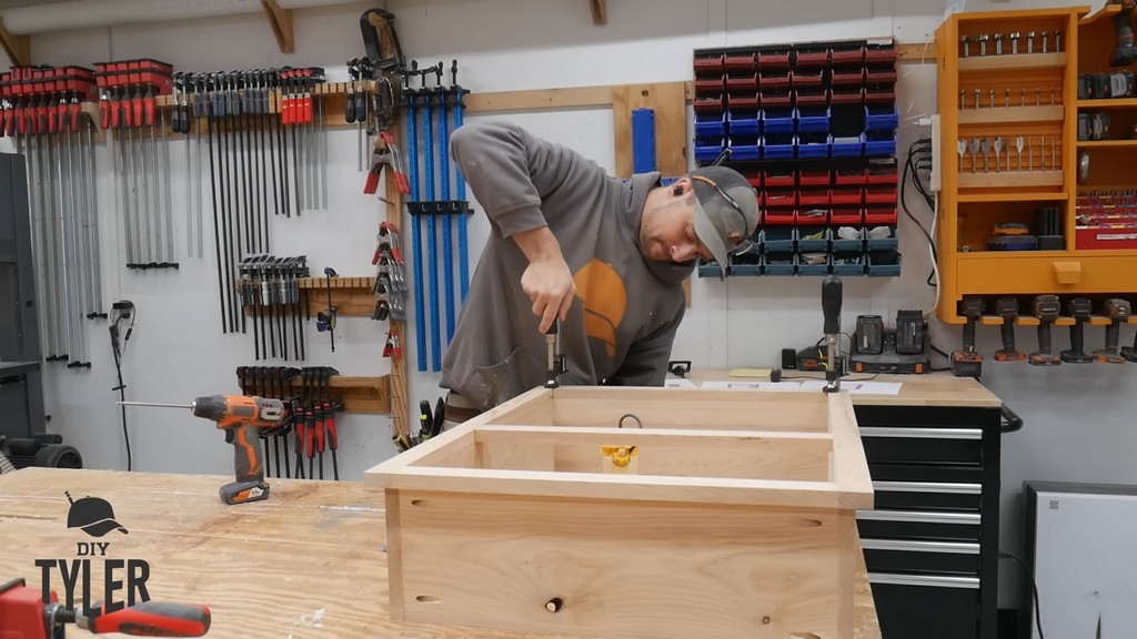 man clamping face frame to box frame for DIY functional bathroom shelf