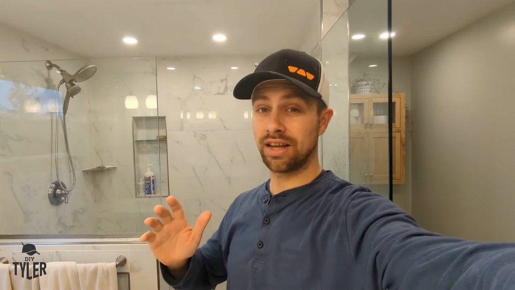 man standing in front of finished walk-in shower