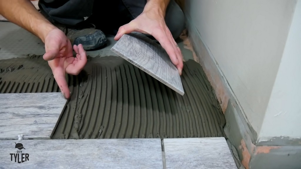 man demonstrating edge of bathroom tile