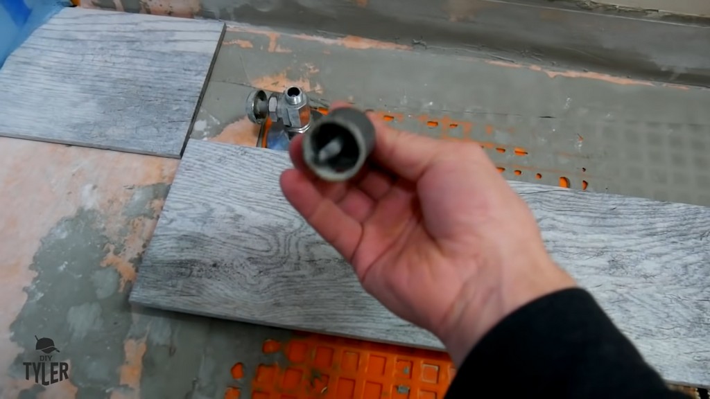 man holding up carbide-tipped hole saw bit