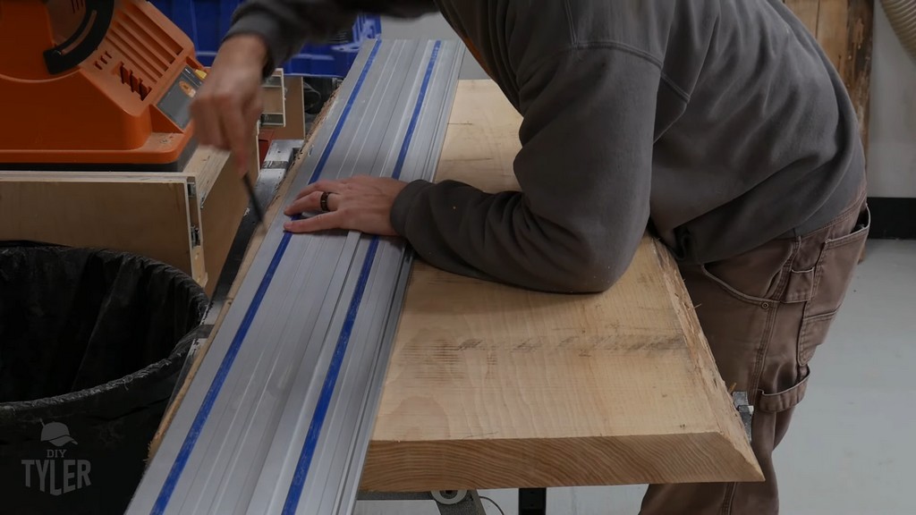man making cut marks on hickory board for DIY round coffee table