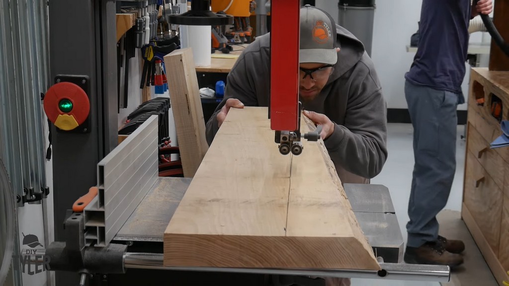 man running hickory board through band saw