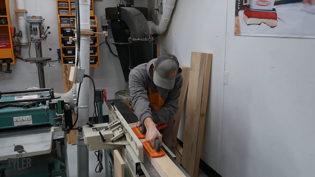 man running hickory board through milling jointer