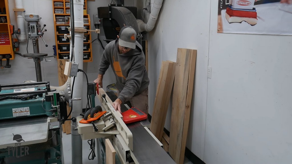 man running hickory board through milling jointer