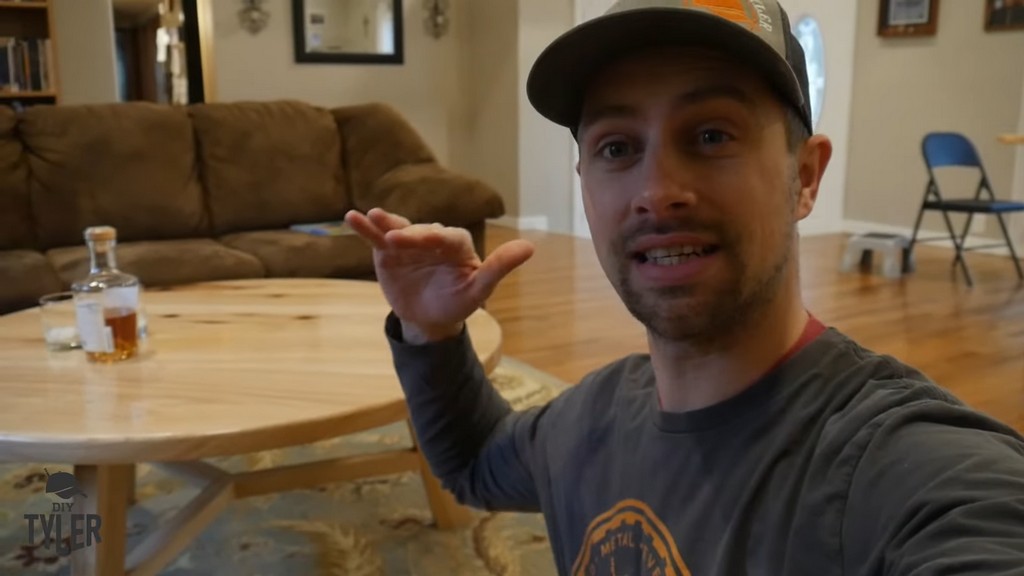 man demonstrating completed DIY round coffee table