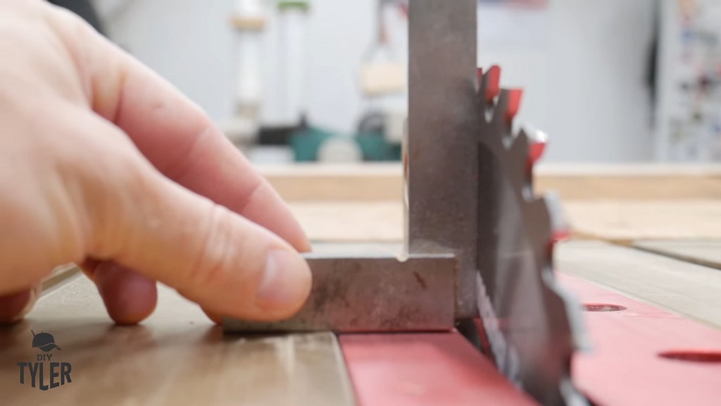 man checking table saw blade for square