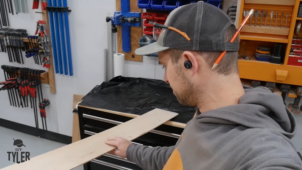 man demonstrating jury-rigged radius jig with and plywood