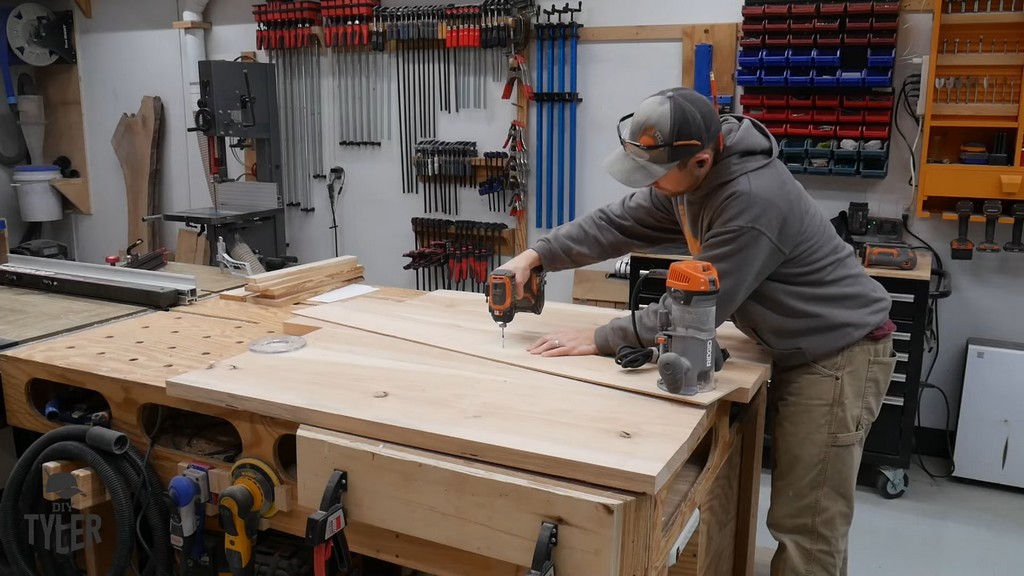 man drilling makeshift radius jig into place