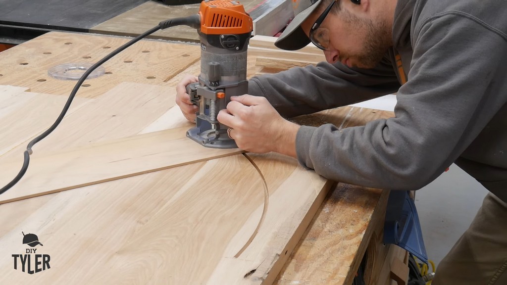 man cutting circle into hickory slab using router and straight bit