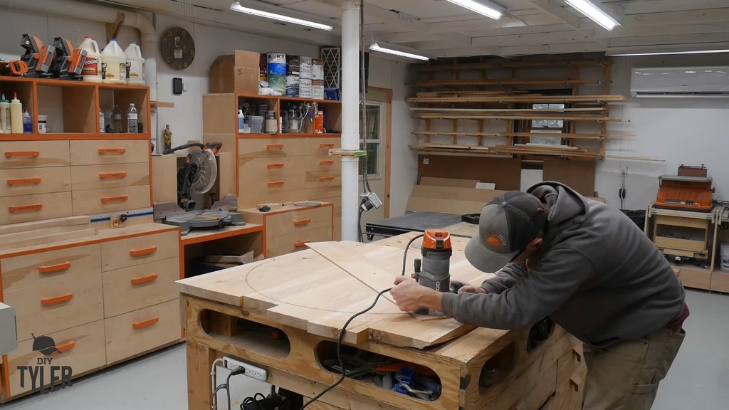 man cutting circle into hickory slab using router and straight bit