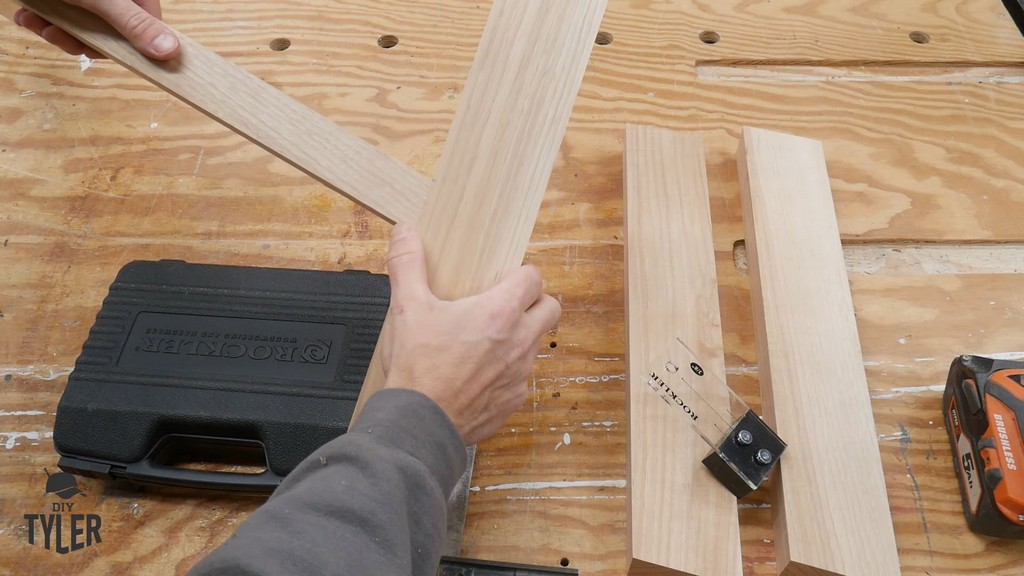 man demonstrating angled table legs and tripod joint brace