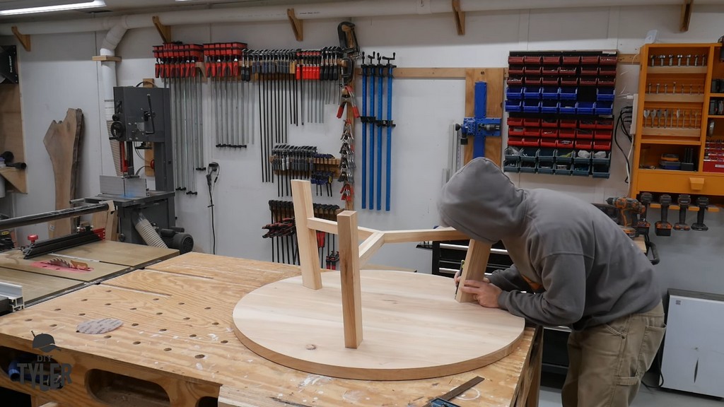 man making markings for pilot holes for DIY round coffee table