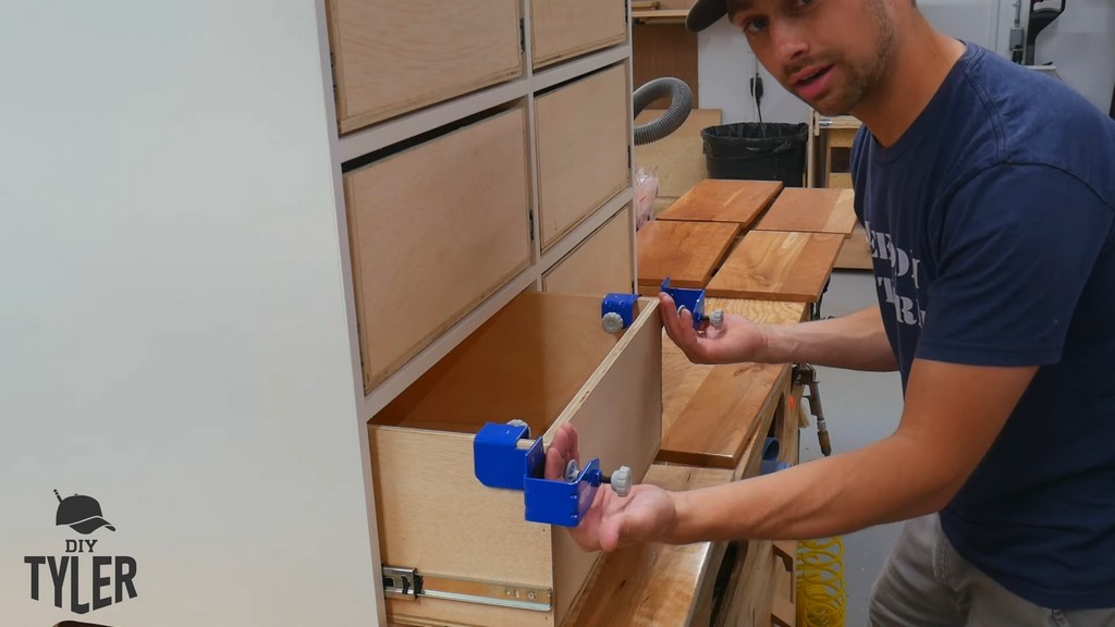 man demonstrating spacing for Kreg drawer front clamps