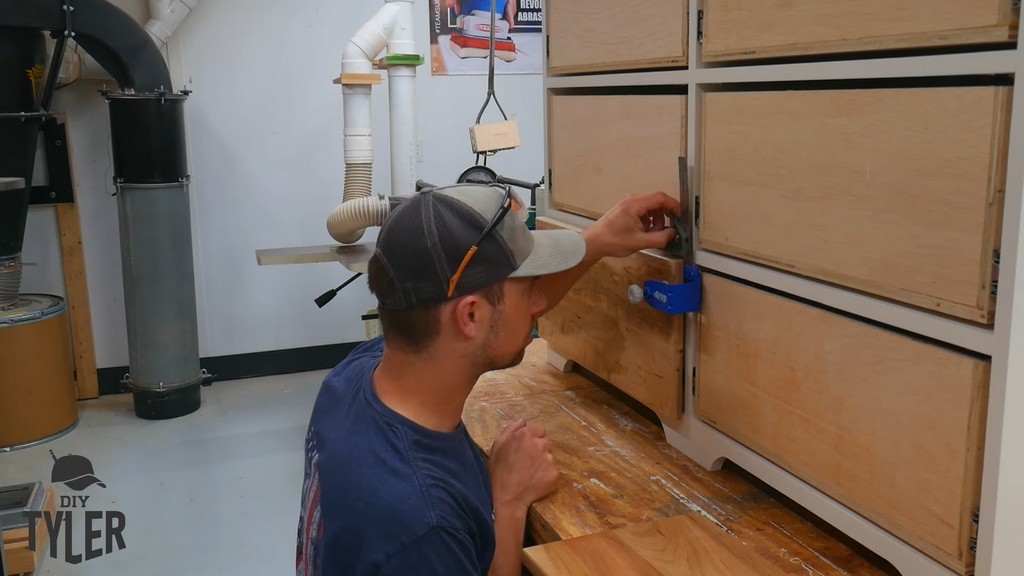 man measuring vertical overhang for cherrywood drawer front