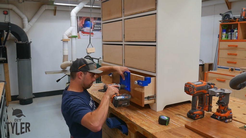 man drilling handle hole into drawer front