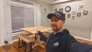 man demonstrating finished pedestal game table