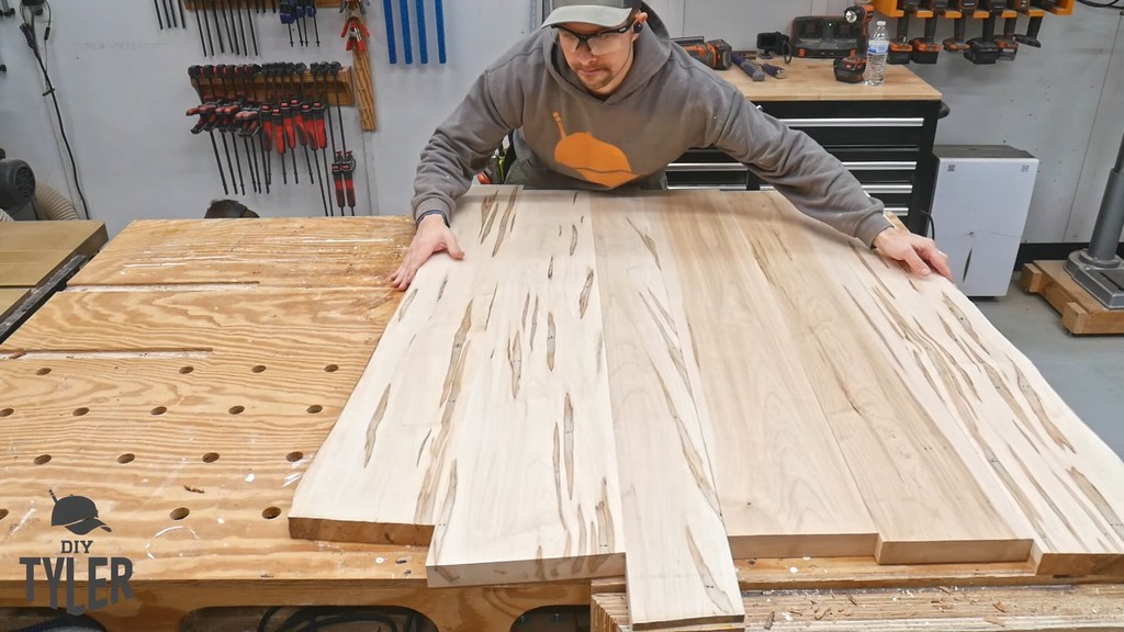 man arranging maple wood slab pieces