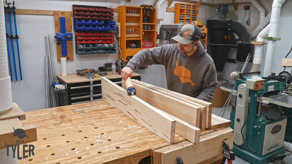 man applying glue to maple wood slab pieces