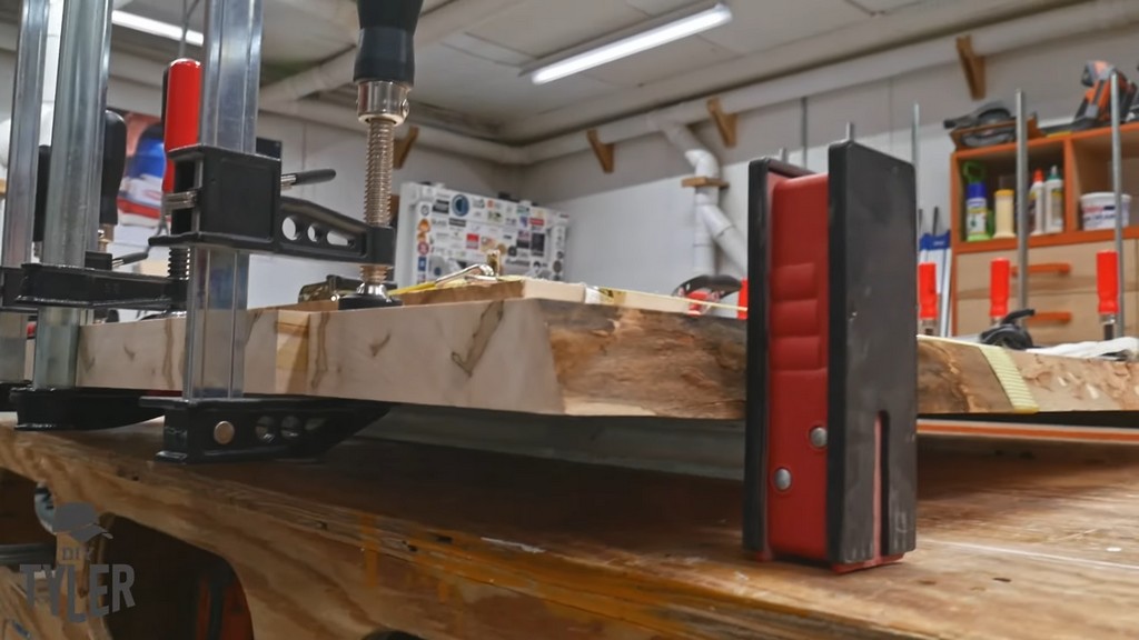 glued and clamped slabs of maple wood for tabletop