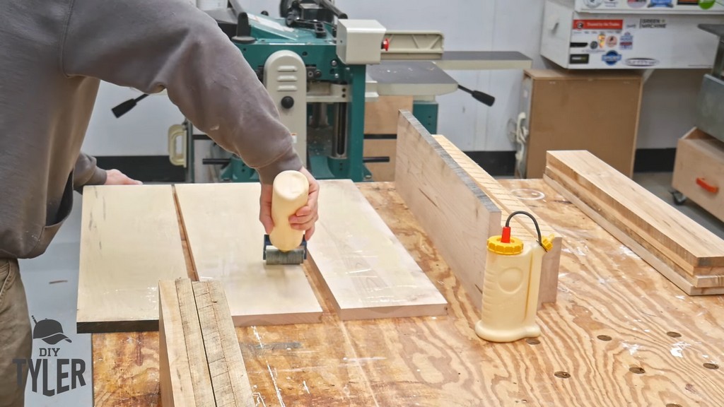 man applying Titebond II glue to maple wood pieces