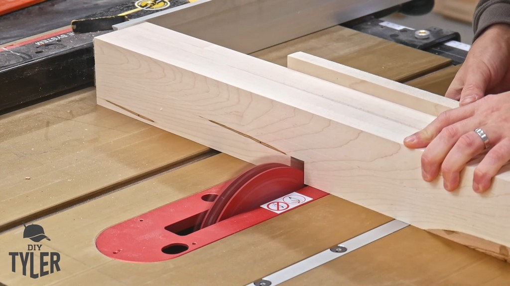 man cutting dado joint with table saw