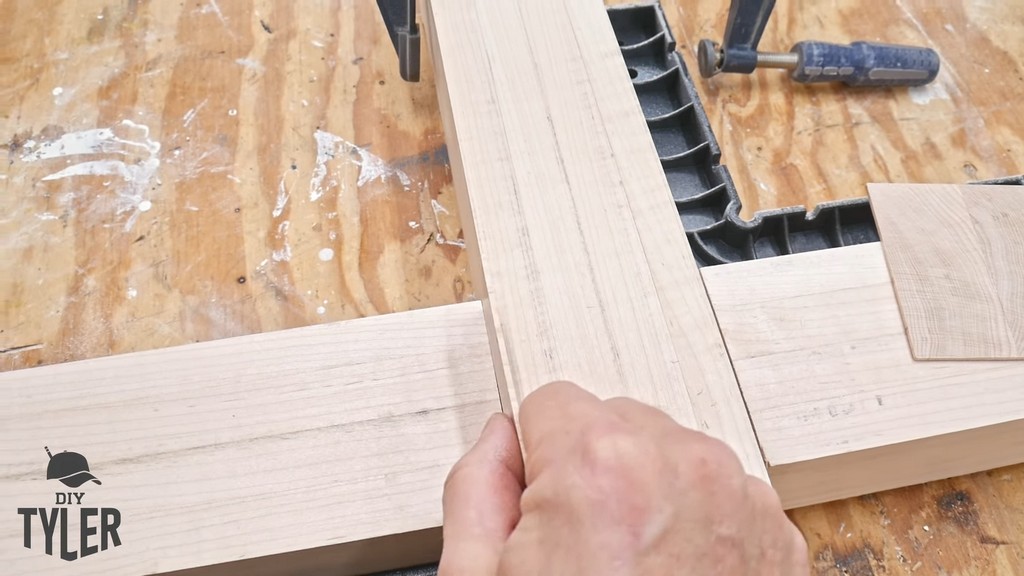 man inserting shim into half-lap joint