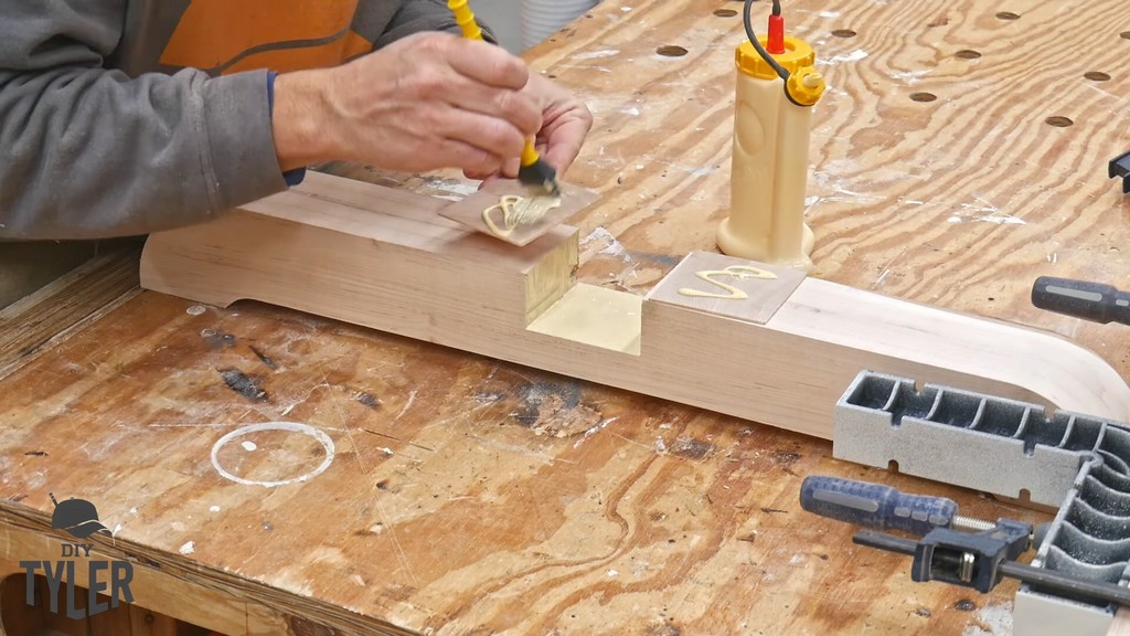 man applying wood glue to half-lap joint